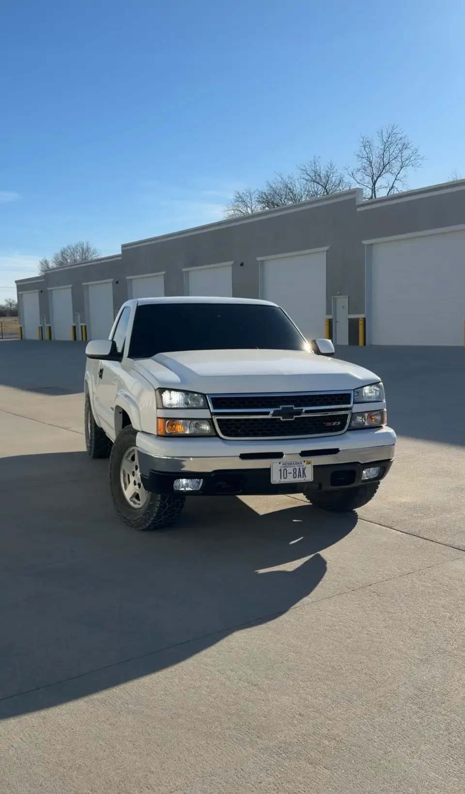 White Chevrolet Silverado truck wrapped in the workshop